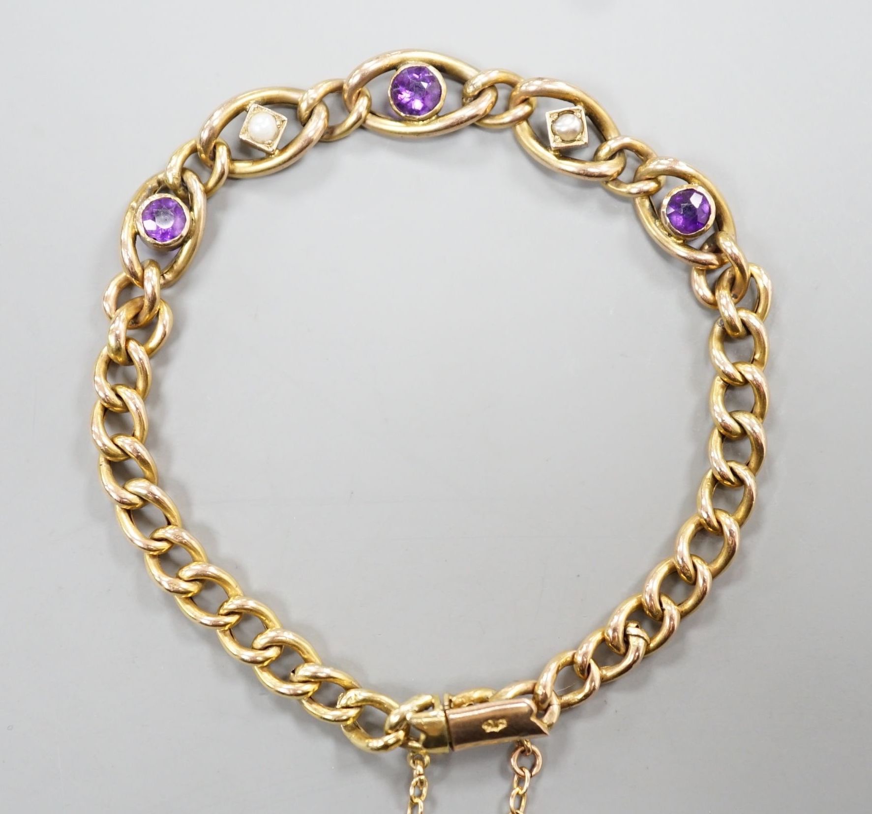 An Edwardian 9ct, amethyst and seed pearl set bracelet, 18cm, 6.1 grams.